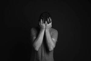 black and white image of man looking sad