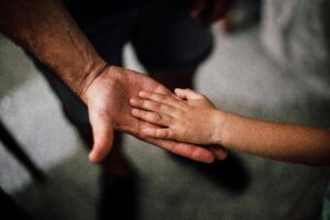 adult hand and child hand