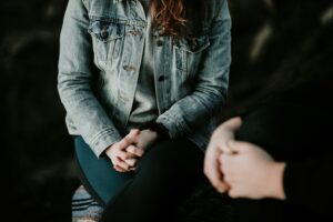 person sitting in therapy session